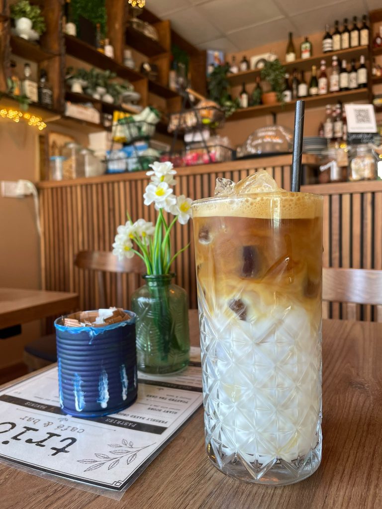 Iced coffee on a table inside Trio Cafe & Bar, York