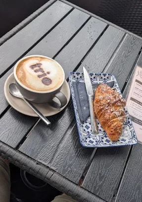 Barista coffee and croissant to take away from Trio Cafe & Bar, York