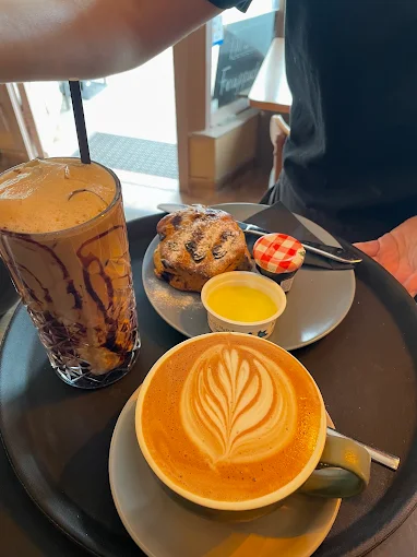 Iced coffee, latte and scone with jam and cream at Trio Cafe & Bar, York
