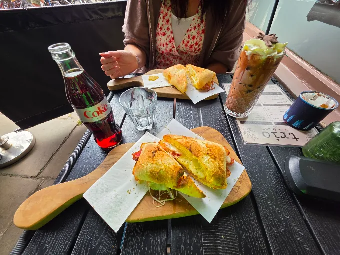 Toasted paninis and drinks at an outside table at Trio Cafe & Bar, York